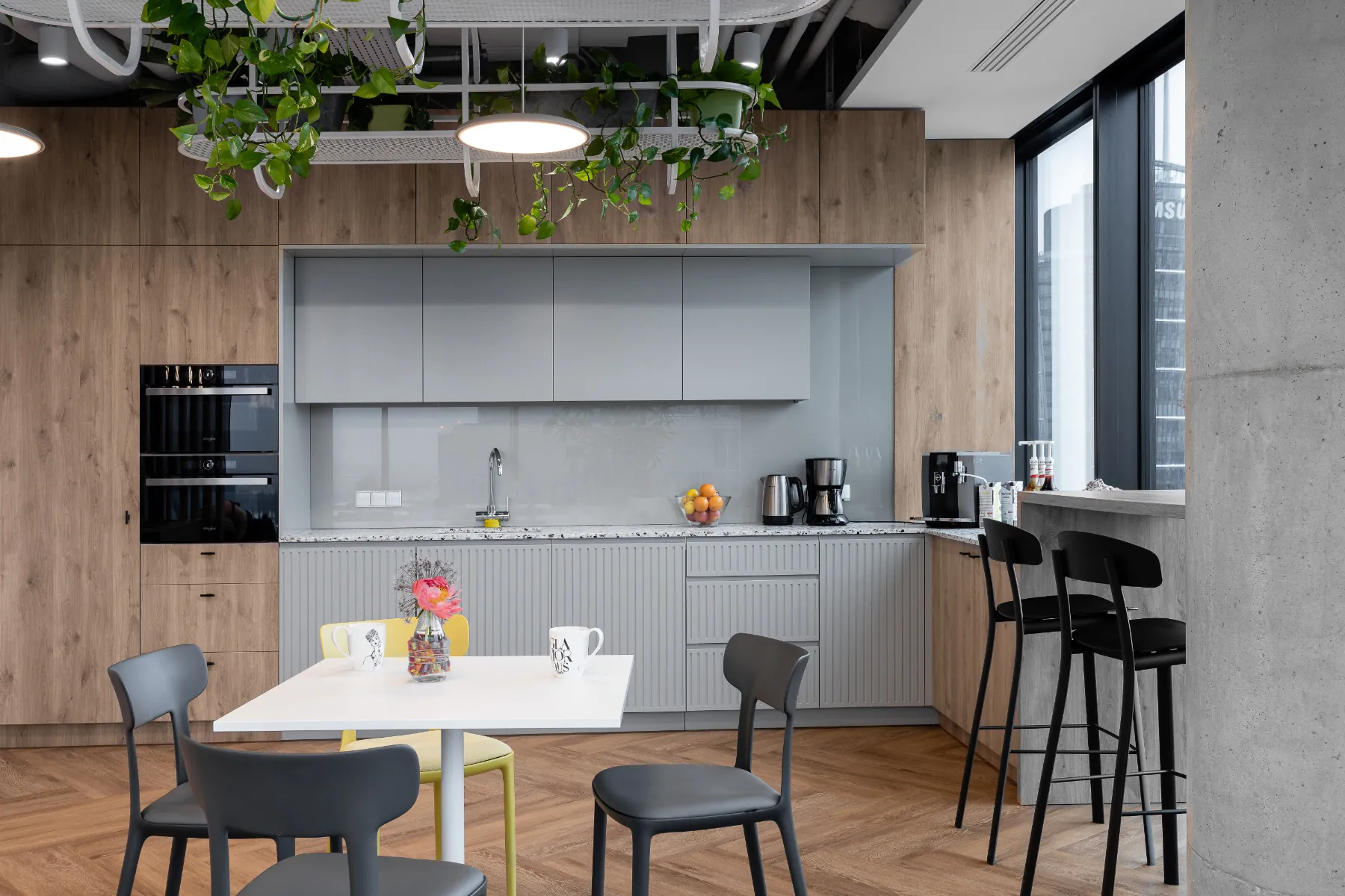 Office café with wood cabinetry and a high-rise view