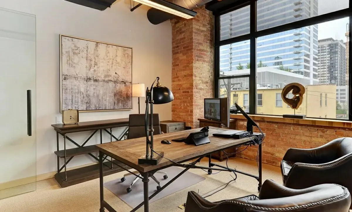 Private office with exposed brick and a city view